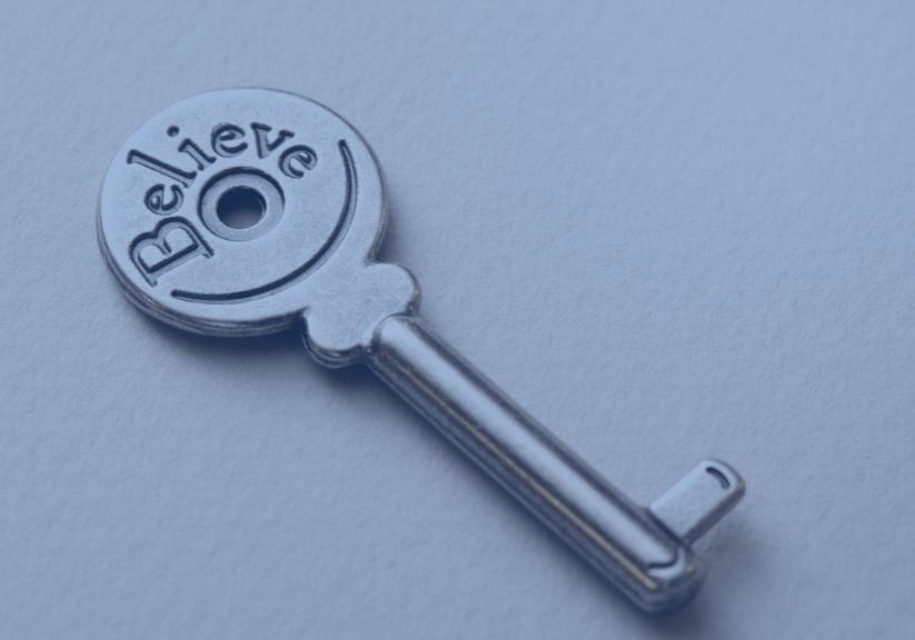 Image with key engraved with the word believe