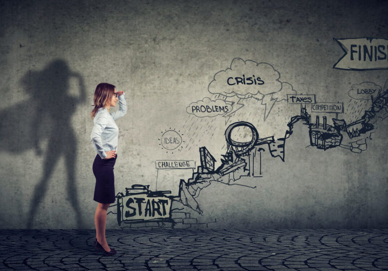 Businesswoman imagining to be a super hero looking aspired making career plans