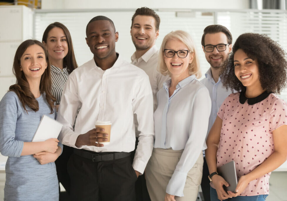Positive multi racial corporate team posing looking at camera