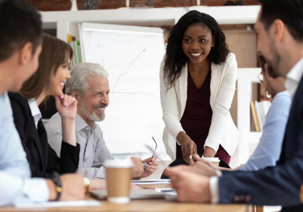 Diverse businesspeople gathered together for negotiations lead by african businesswoman